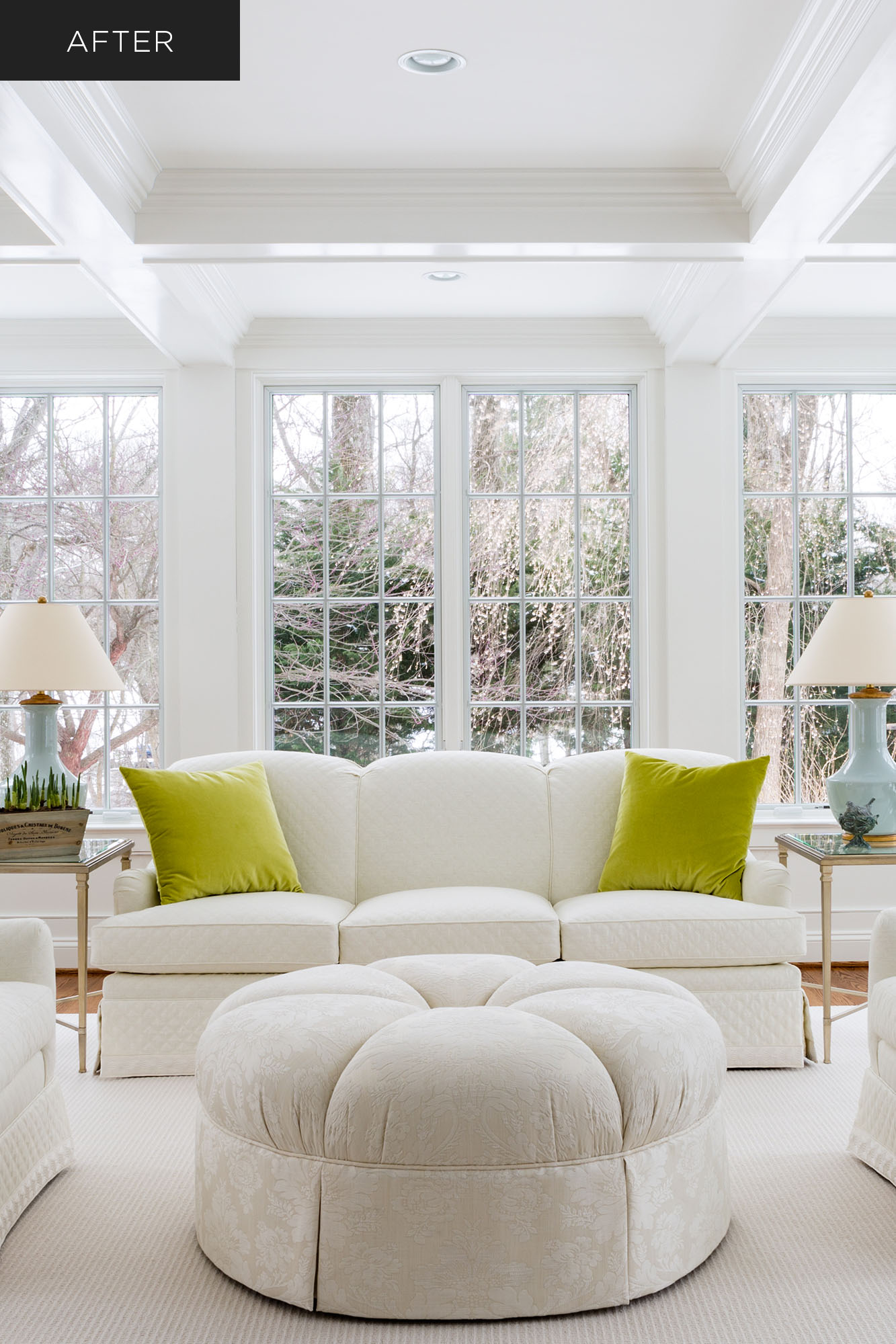 Home sunroom renovation with soffit ceiling, white furniture, white windowpanes and view of snowy landscape