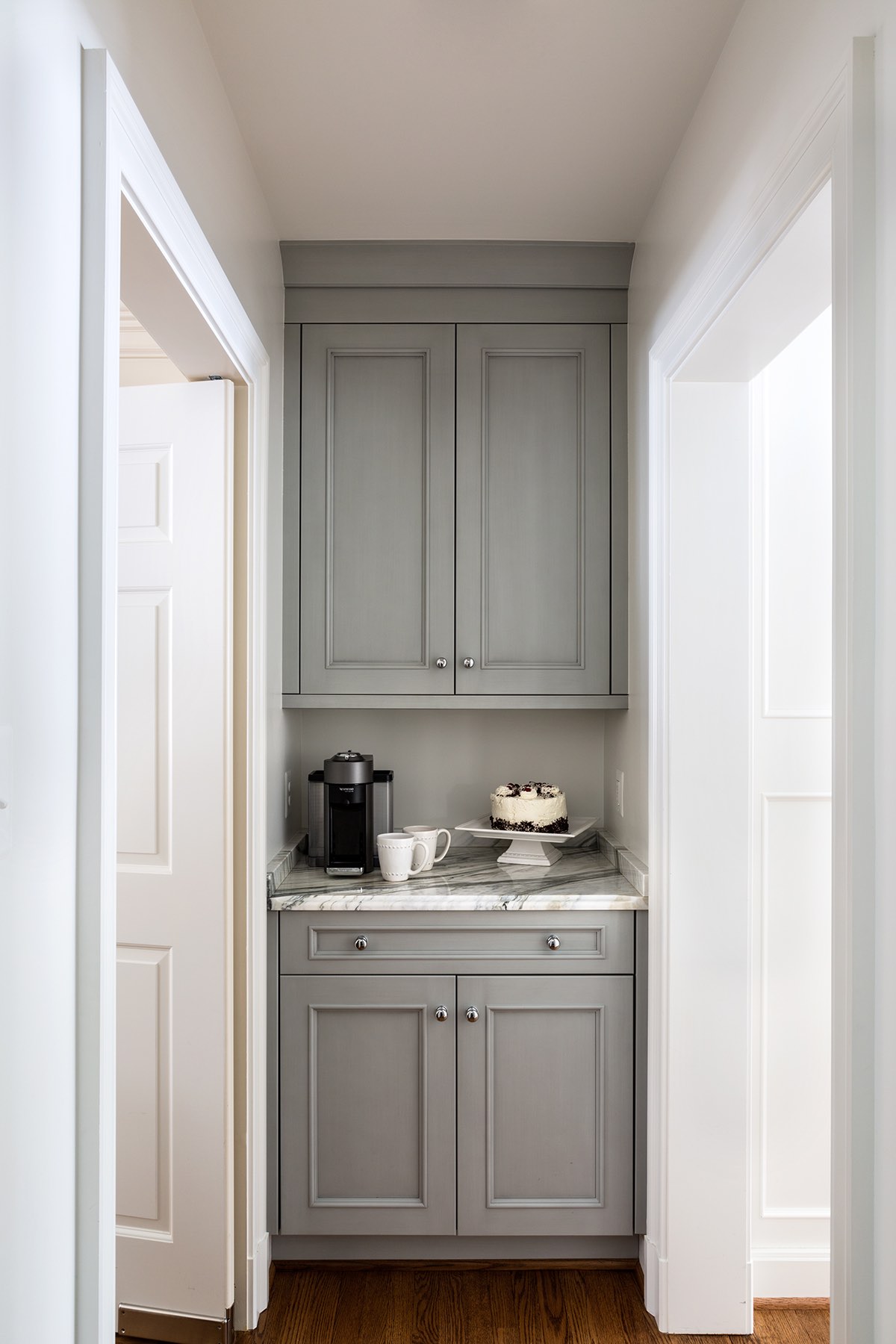 Custom-built butler’s pantry off home kitchen with gray cabinetry