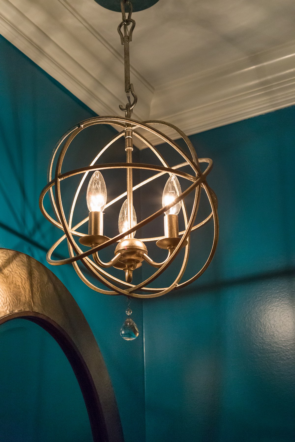 Powder room pendant lamp with freeform brass cage shade